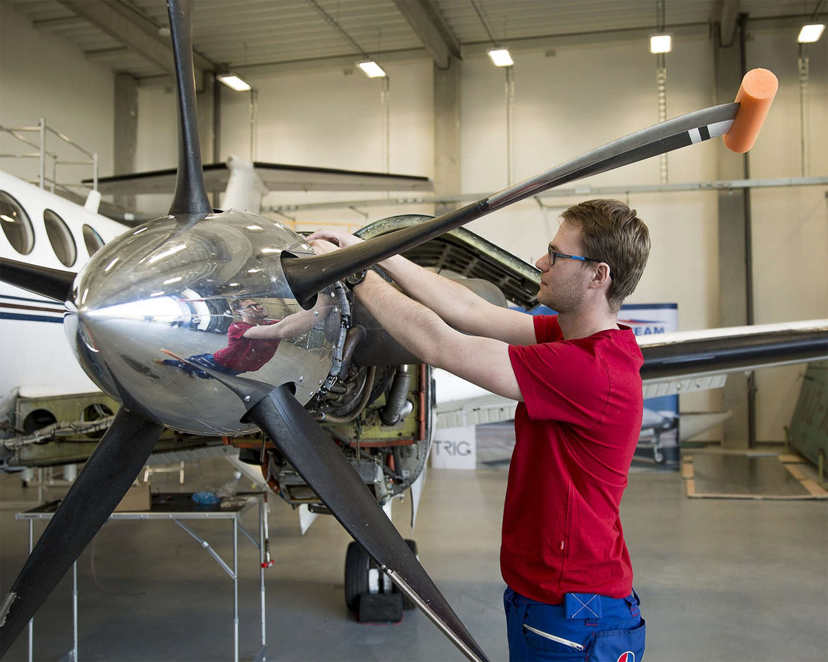 AIR TEAM technician working on a turboprop in the Kunovice hangar