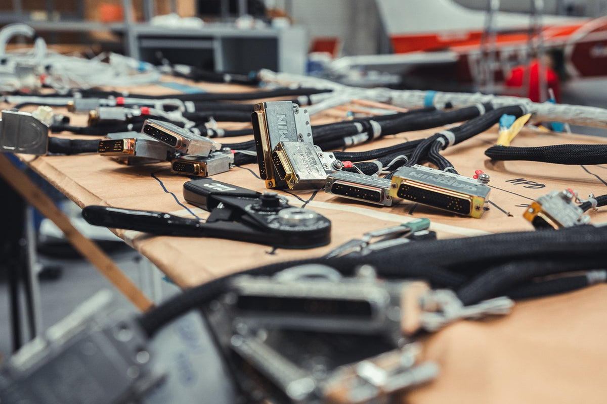 Avionics wiring harnesses being assembled on the AIR TEAM workbench