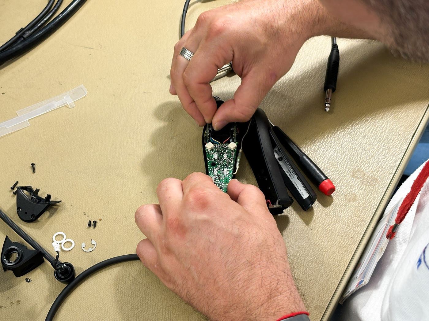 AIR TEAM technician repairing an aviation headset
